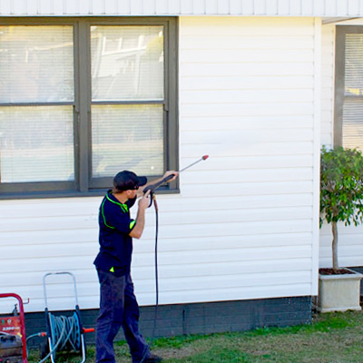 Washing down the exterior wall of a house.