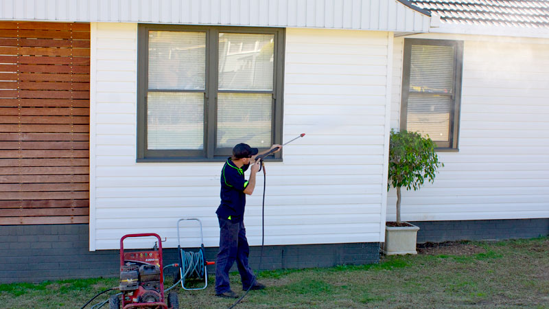 The exterior wall of a house being washed down.