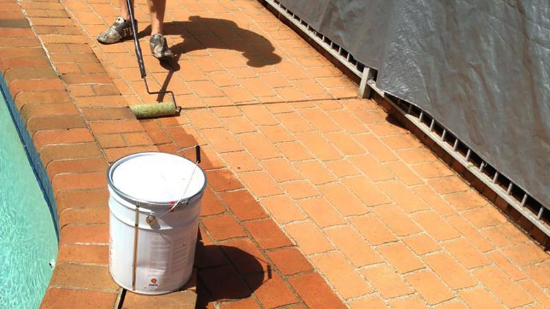 Sealer being applied to a paved area.